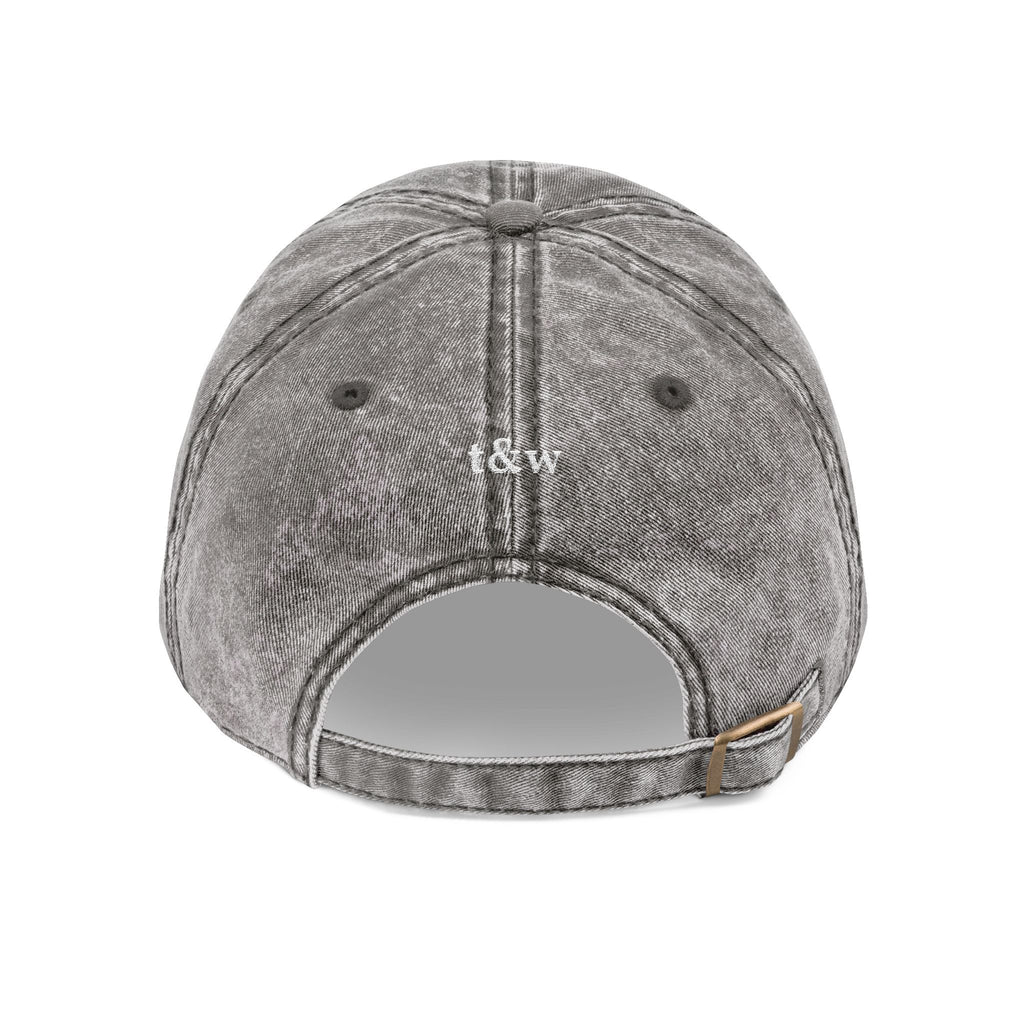 Back view of a washed grey denim cap with "spread love" tag 